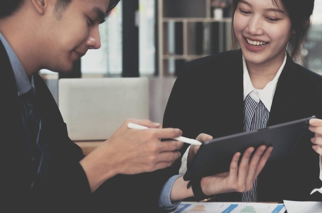 Fund managers team consultation and discuss about analysis Investment stock market by digital tablet